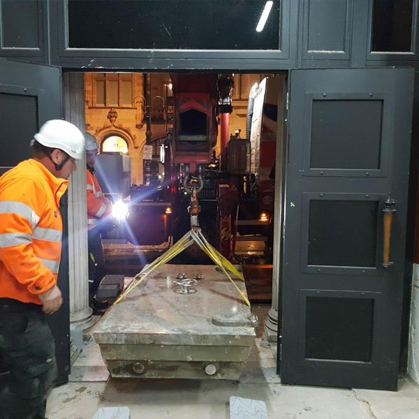 Heavy bank vault door being removed from old lloyds bank.